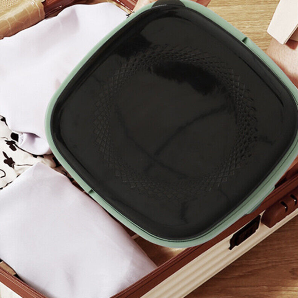 Close-up top view of the washing machine filled with clothes and ready for washing.