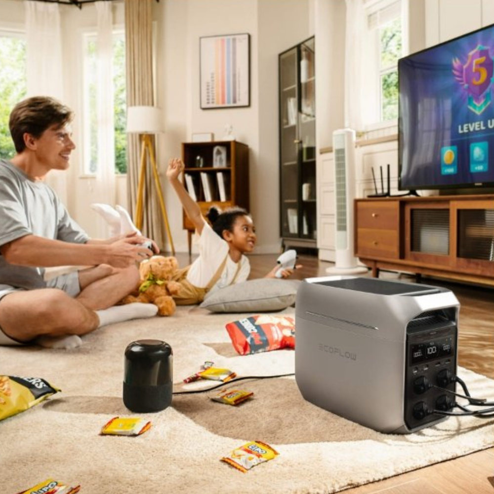 Family watching TV with a portable projector in a living room.