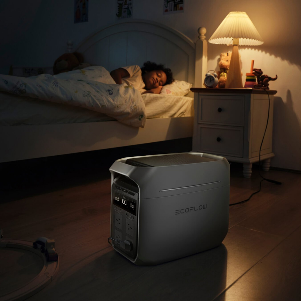 EcoFlow power station on a wooden floor with a child sleeping in the background