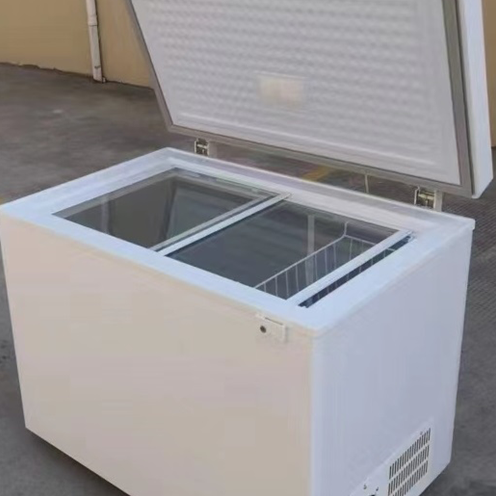 Chest Freezer in Warehouse Setting – A white chest freezer with an open lid, placed on a pallet in a warehouse, showing its deep storage space and sturdy build.