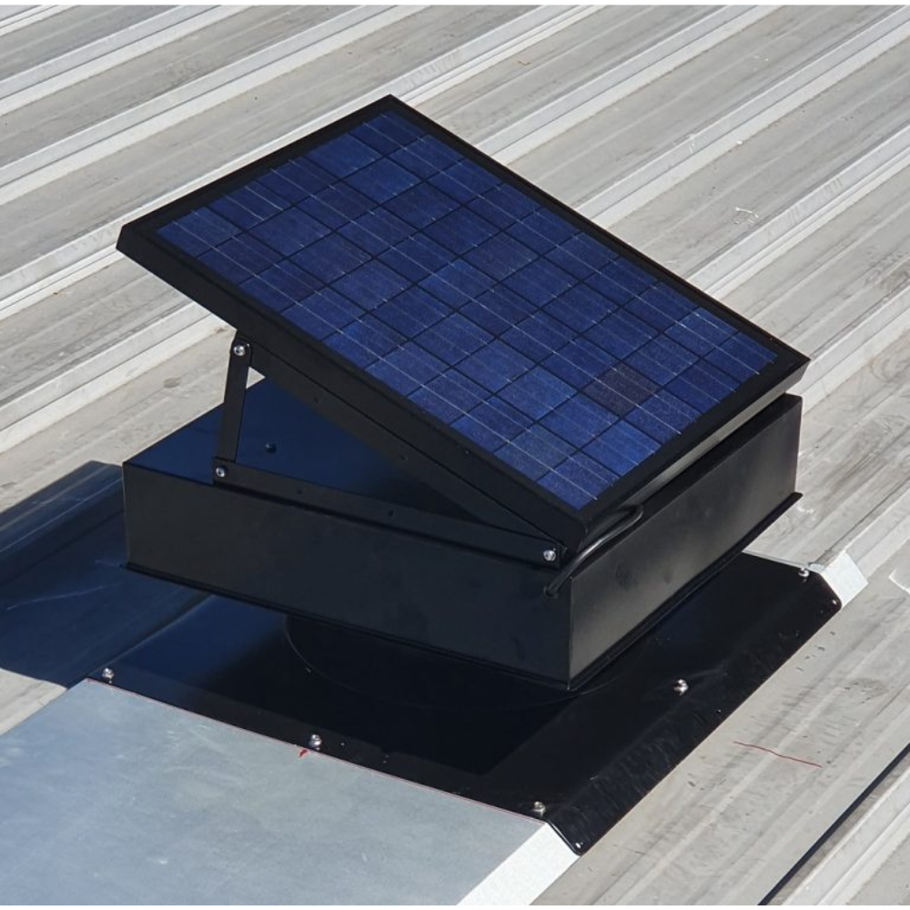 Black solar ventilator with a tilted panel installed on a silver ribbed metal roof.