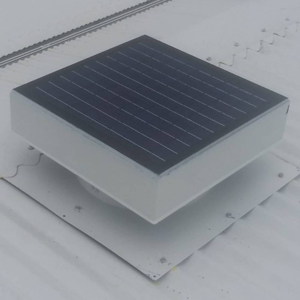 Solar-powered ventilator mounted on a light-coloured metal roof in daylight.