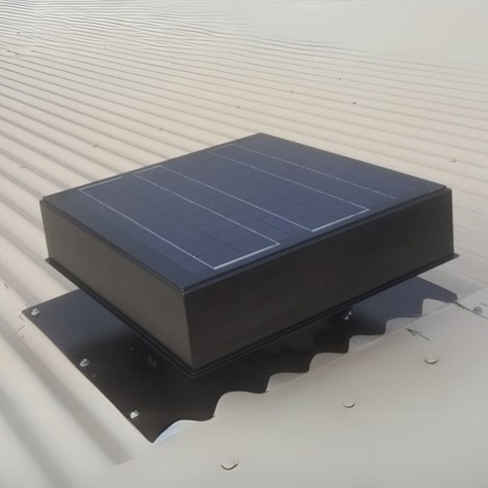 Dark-coloured solar ventilator with visible solar panel mounted on a grey metal roof.