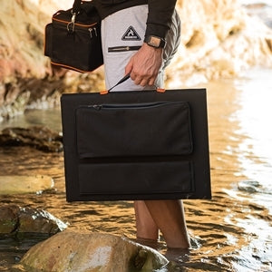 A lifestyle image showing the solar panel being carried by a person outdoors, illustrating its lightweight and travel-friendly design.