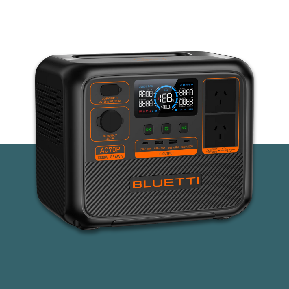 Left-angled close-up of Bluetti unit with screen and output ports visible, placed on a stylised two-tone background.