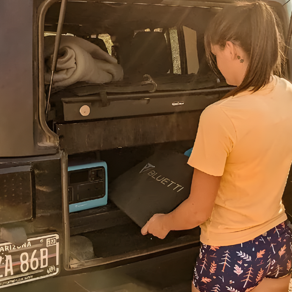 The BLUETTI solar panel and power station are stored neatly in the back of a vehicle, demonstrating the ease of storage and compatibility with other BLUETTI products