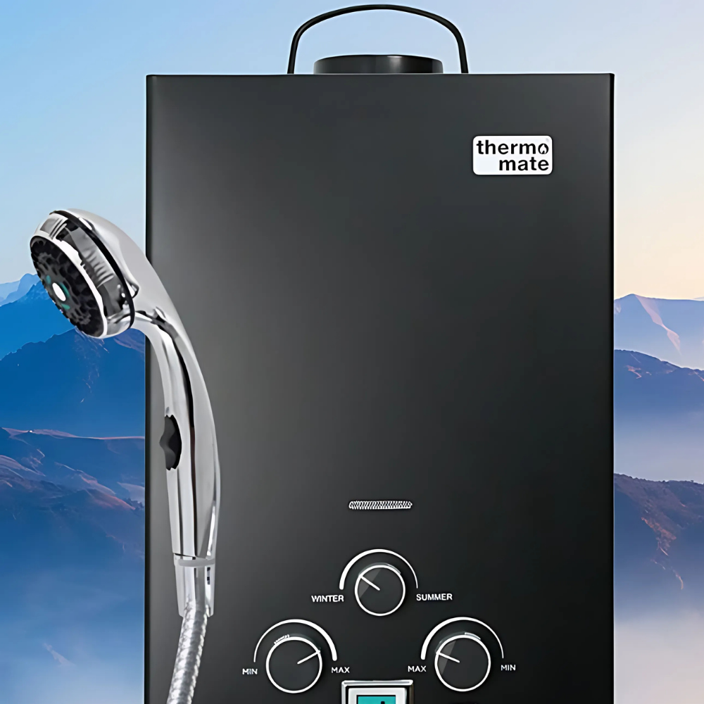 Black Thermo-Mate shower heater with handheld shower head against a mountainous background