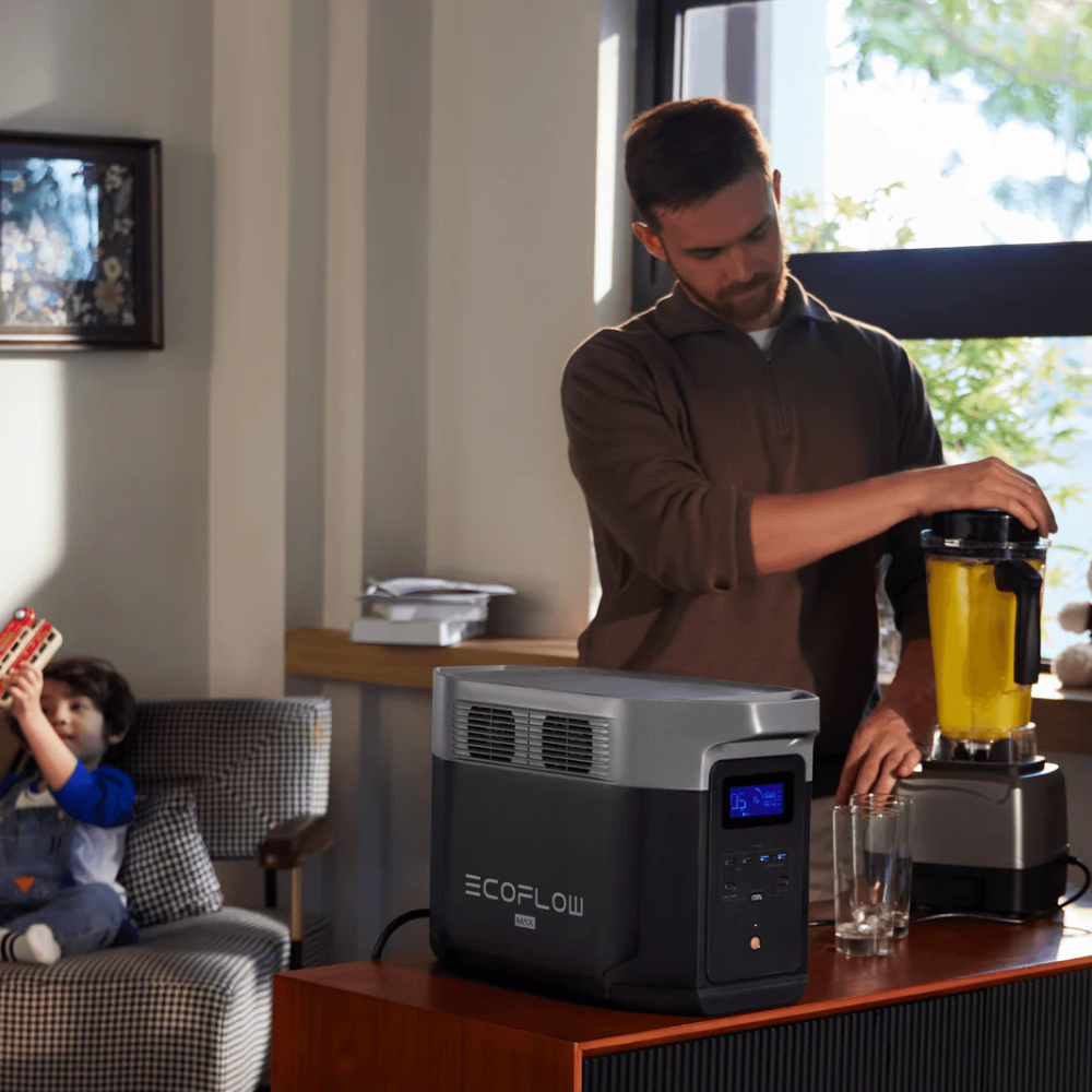 Man using a blender next to an EcoFlow device in a home setting