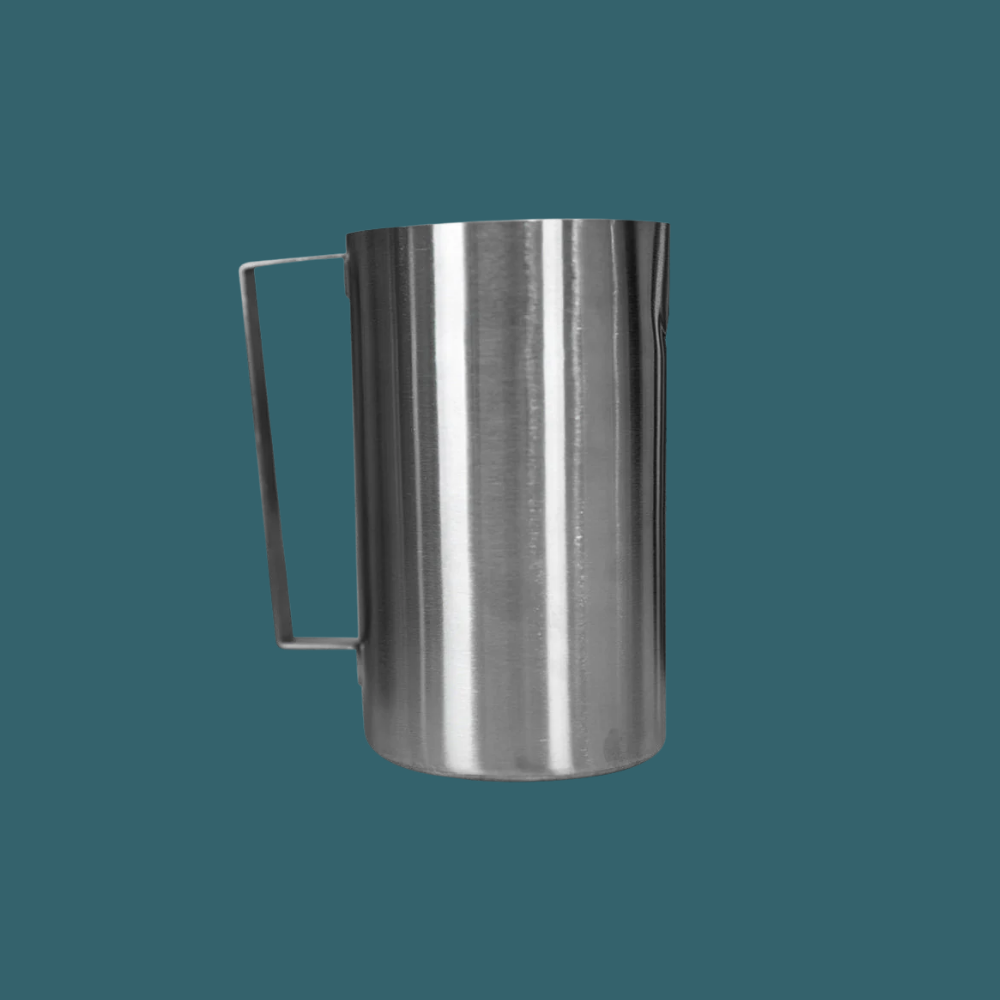 Stainless steel pitcher on a teal background