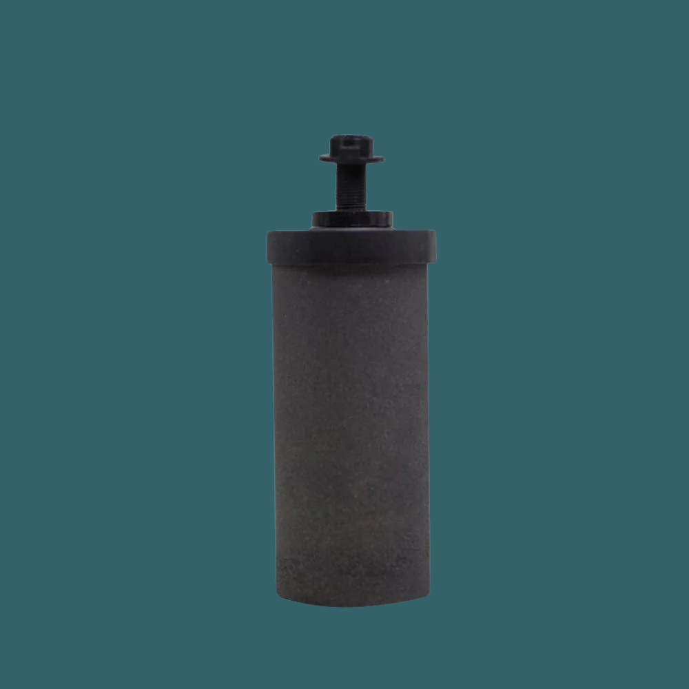 Black carbon filter cartridge, upright on teal background, used for gravity filtration systems.