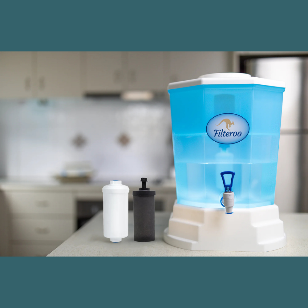 Filteroo blue water filter system with white base, set on a kitchen bench alongside a white and black filter cartridge.