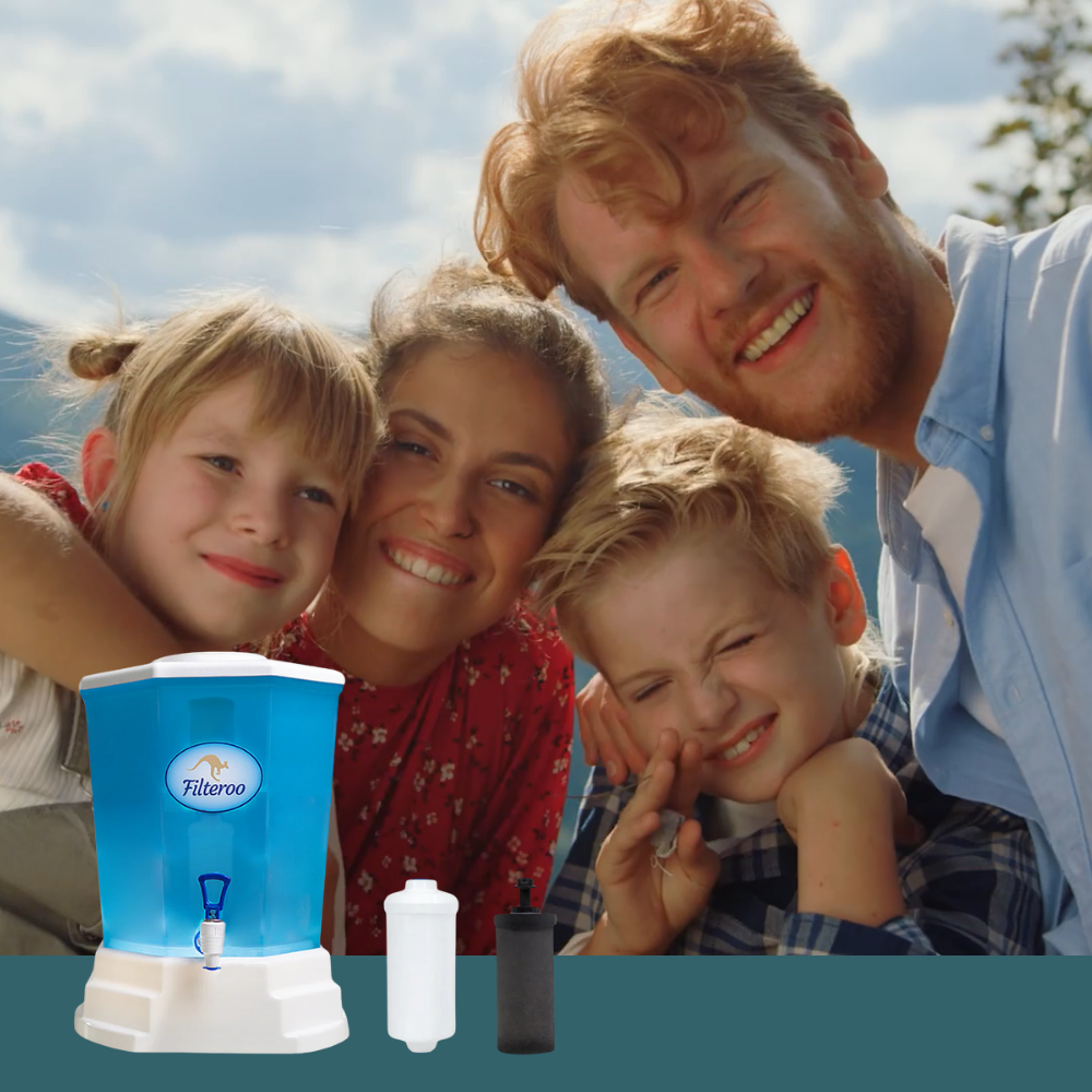 Smiling family with Filteroo filter, including young children, gathered around the blue unit in a home setting.