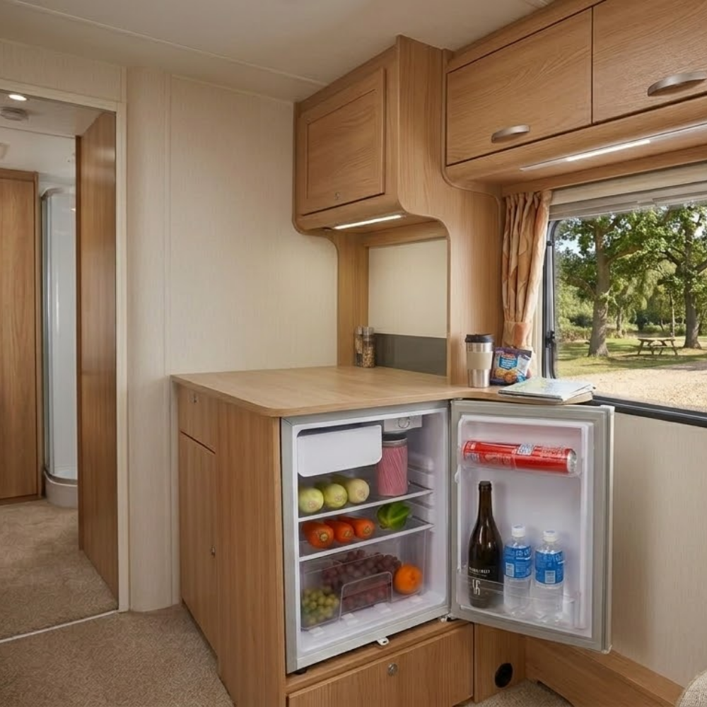 GECKO 70L 12V/24V Portable Upright Fridge Freezer in a caravan kitchen with food items and drinks.