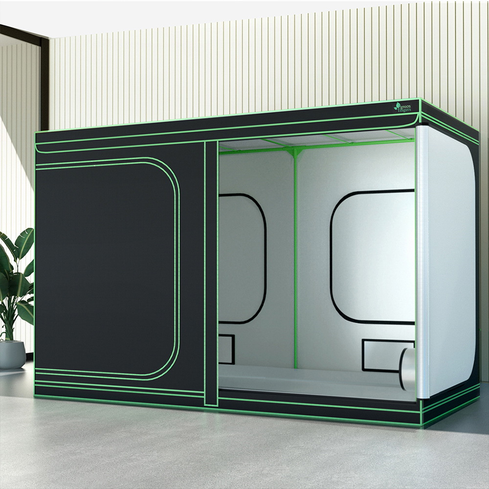 Large indoor hydroponics grow tent . The black exterior features green piping and multiple ventilation ports.