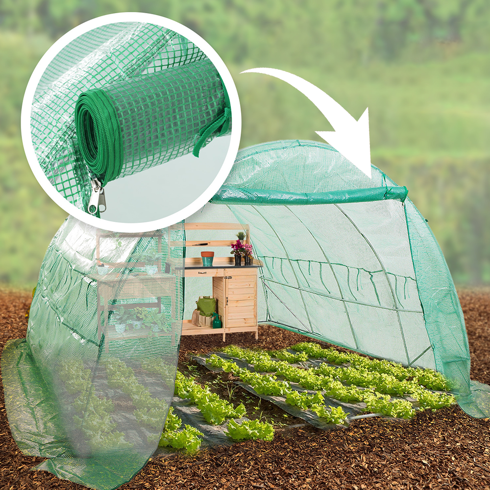 A green tunnel greenhouse set up outdoors with plants inside and a small wooden shelf. An inset circle highlights a close-up of a rolled-up section of the greenhouse cover with a zipper.