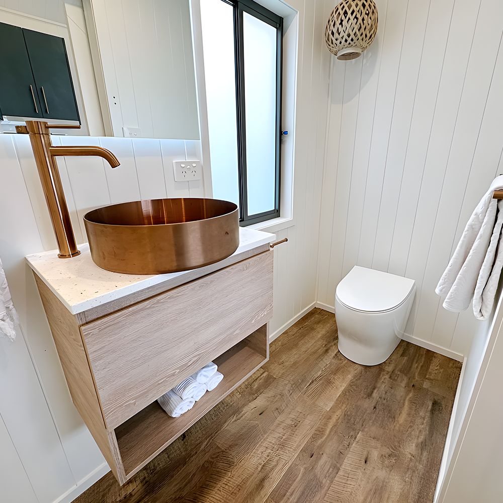 Modern bathroom with composting toilet – A stylish, minimalist bathroom featuring a Nature Loo Alectura composting toilet with a porcelain pedestal.