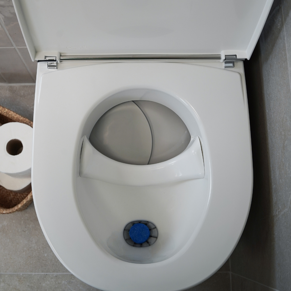 White Separett Tiny® Composting Toilet With Urine Tube with open lid in a bathroom setting