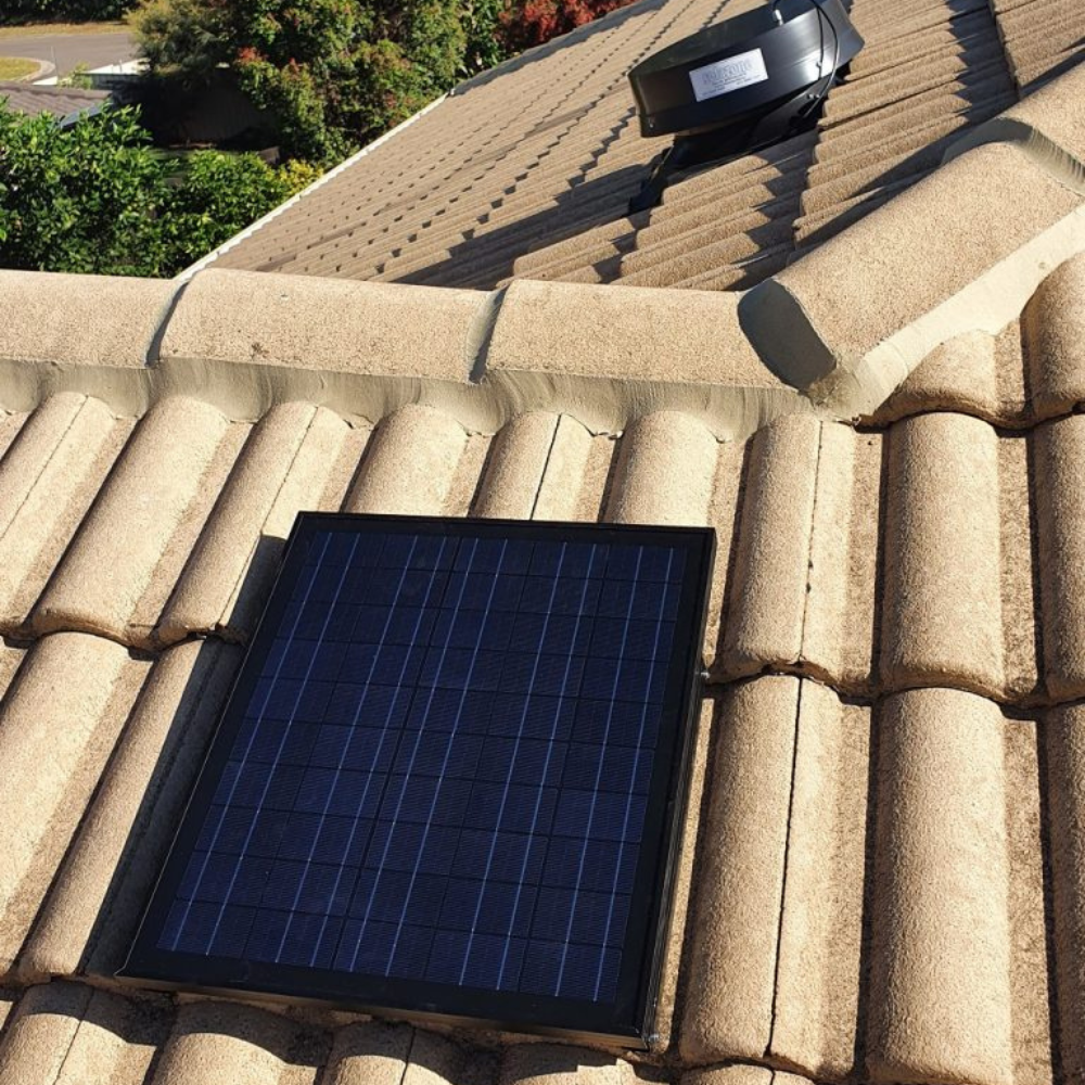 Solar roof ventilator installed on terracotta tiles.
