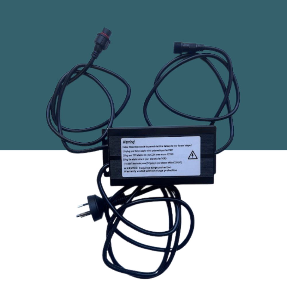 A black power adapter unit is shown with cables, featuring a warning label about connection order and surge protection requirements.