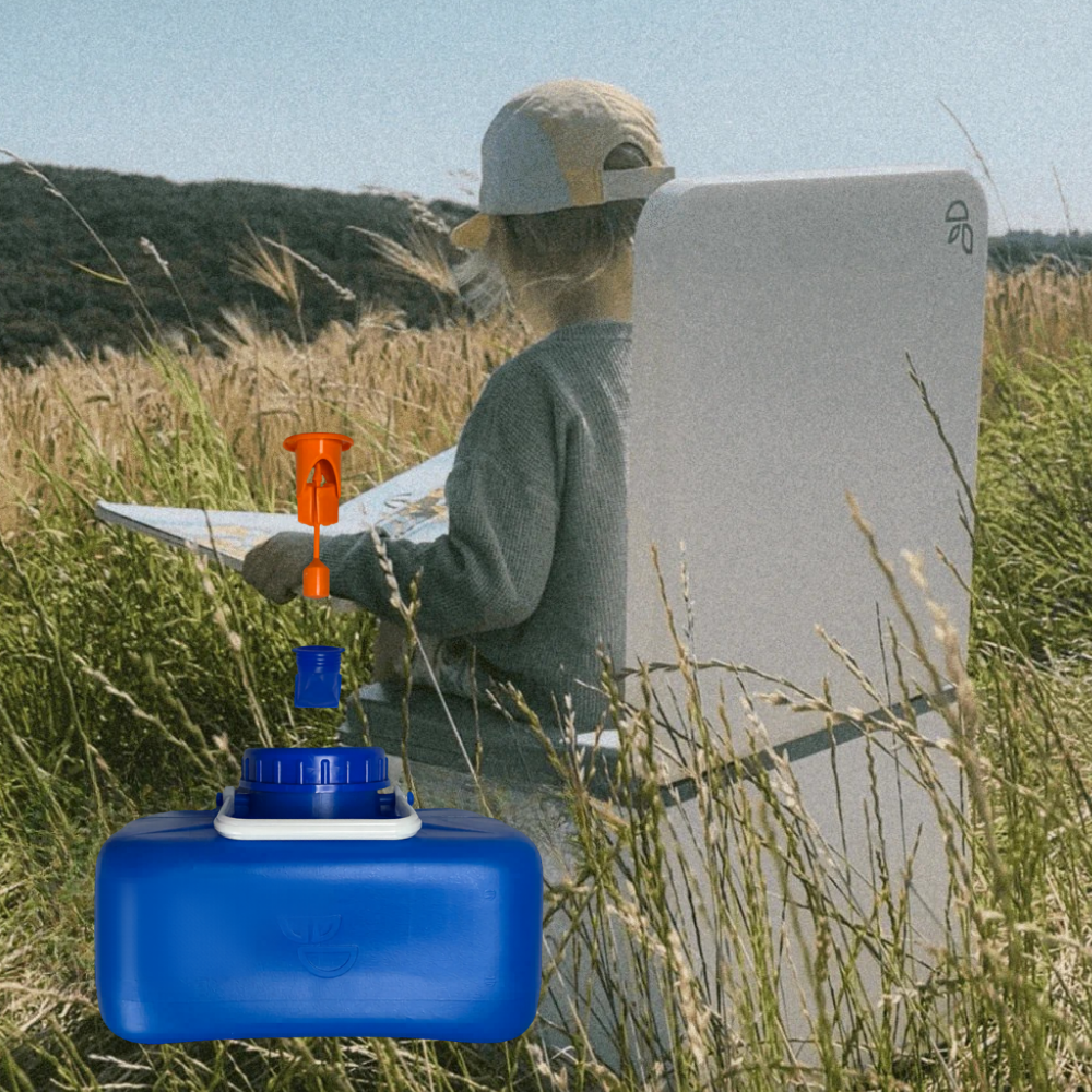 Person in a field using a device with a blue container and orange and blue nozzles.
