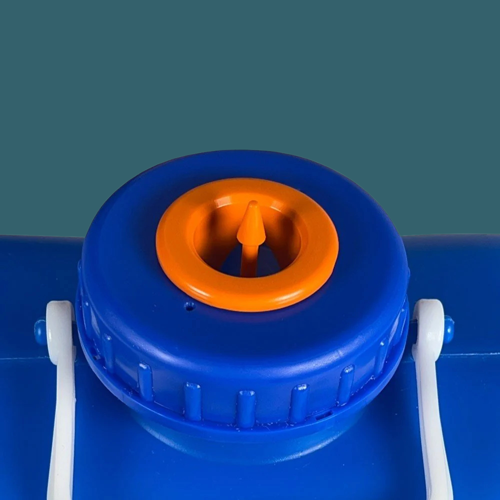 Close-up of a blue container with an orange valve on a green background