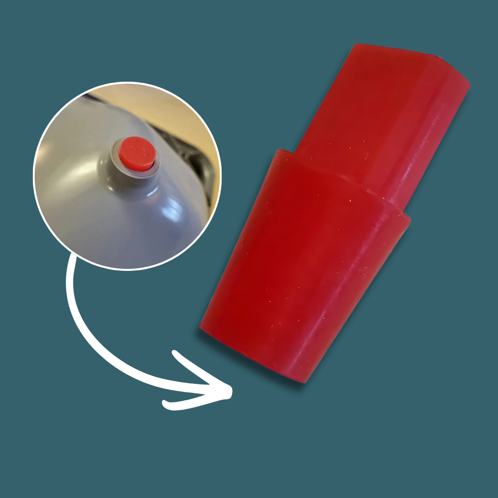 Red plastic component with a red button on a teal background