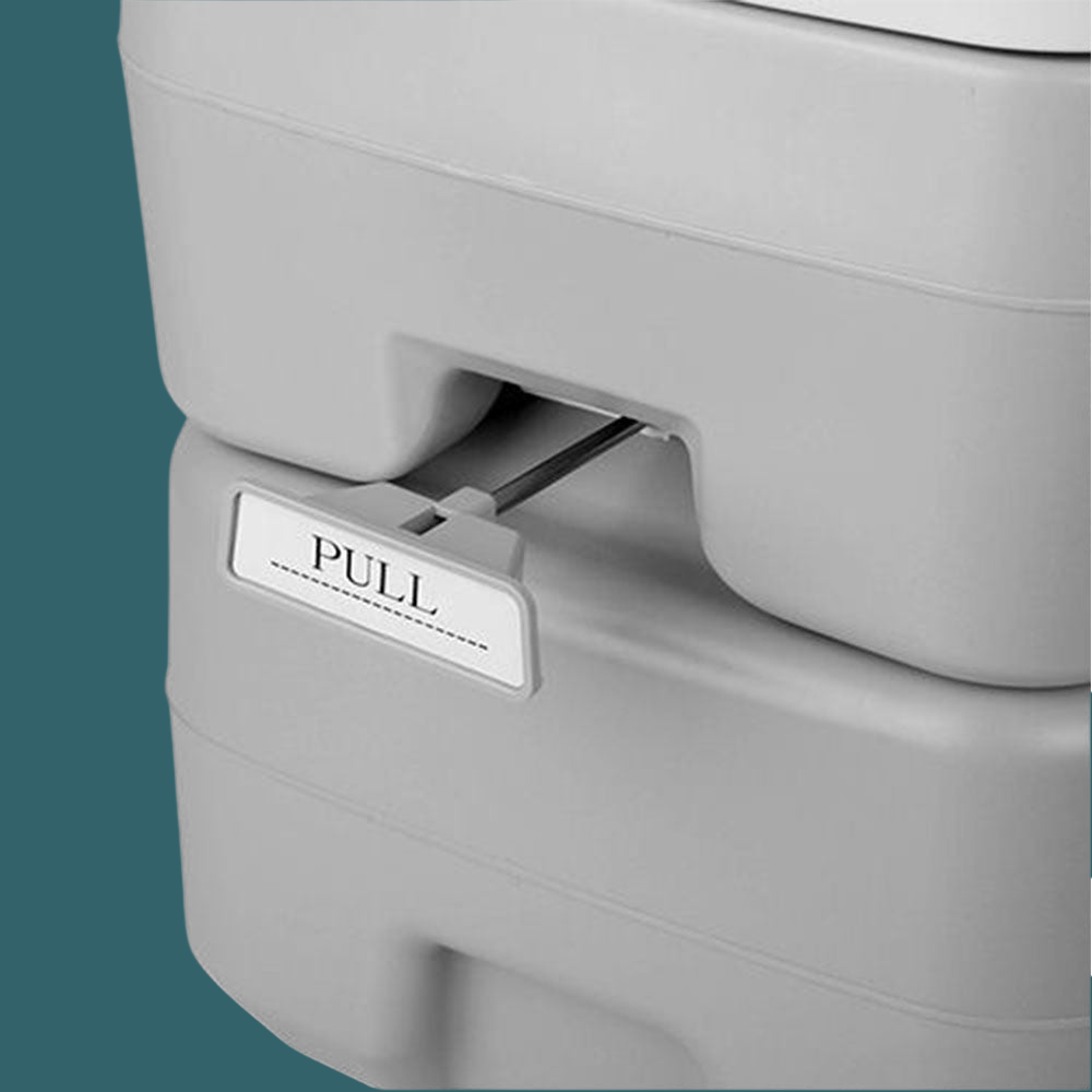 Close-up of locking latch on the waste tank with product label visible.