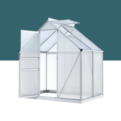 A compact aluminum greenhouse with translucent polycarbonate panels, a sliding door, and an adjustable roof vent for airflow.
