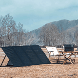 Solar panels in an outdoor setting with mountains and trees in the background