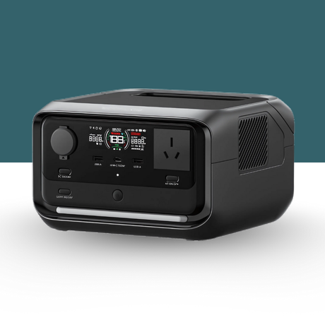 Portable power station with display and multiple ports on a teal background – A compact black power station unit with LED screen and input/output ports shown at an angle.

