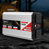Power inverter placed on rugged outdoor ground, highlighting its use in industrial or remote settings.