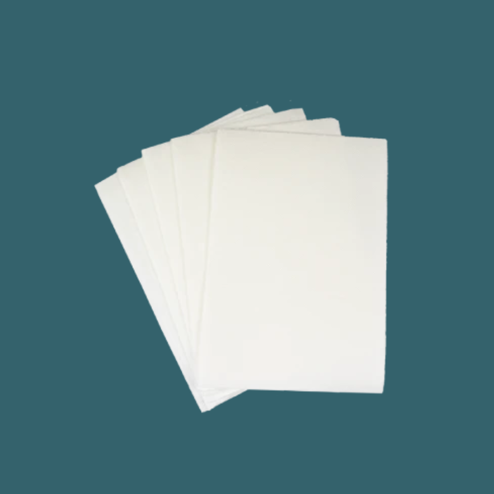 Set of Separett Tiny® absorb pads displayed against a plain teal background.
