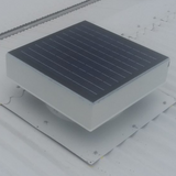 Solar-powered ventilator mounted on a light-coloured metal roof in daylight.