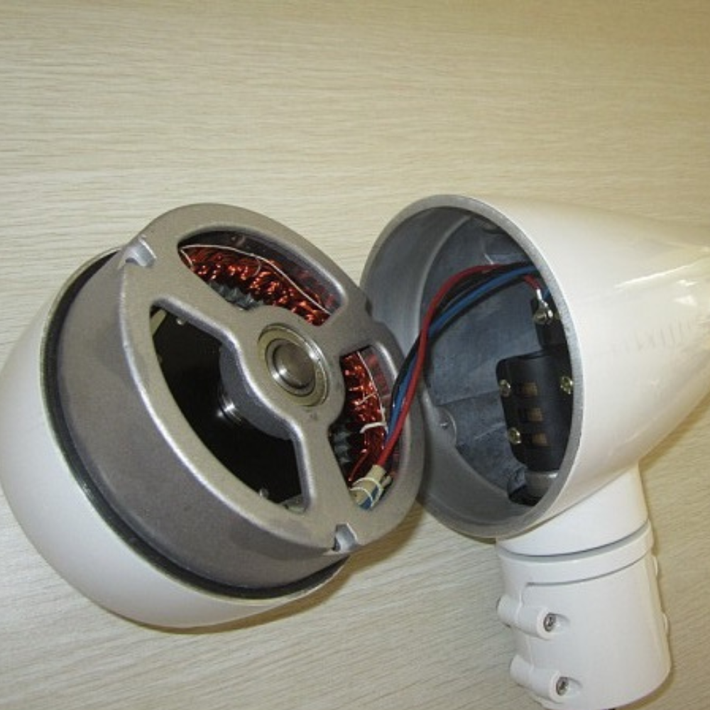 Close-up of the internal components of the wind turbine, revealing copper wiring and motor assembly.