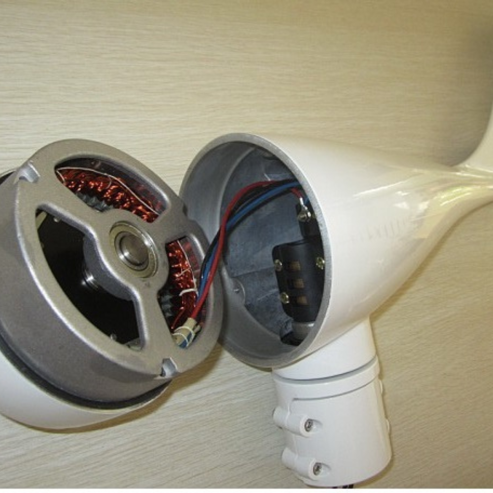 Inside View of a Marine Wind Generator Motor – A close-up image of a disassembled marine wind generator, showing the internal copper wiring, rotor, and electrical connections.