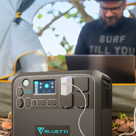 Camping Use Case: Demonstrates the BLUETTI AC200MAX in a camping setting, powering devices for remote work or recreation. The vibrant display and compact form make it a must-have for outdoor enthusiasts.