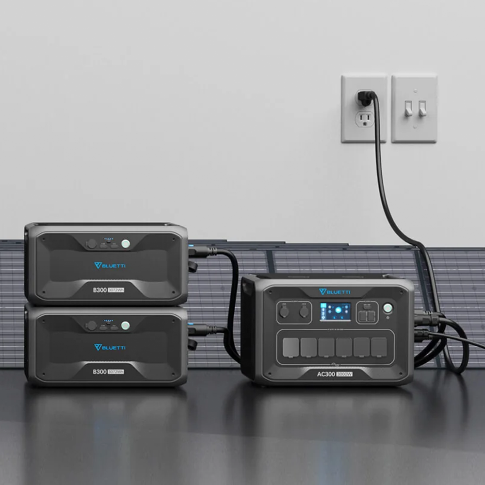 A setup of the Bluetti AC300 with two B300 battery modules and connected solar panels, demonstrating its compatibility with solar energy and indoor charging setup.