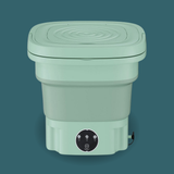 Green collapsible washing machine on a teal background