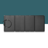 Black solar panel with a cable on a white surface with a teal background