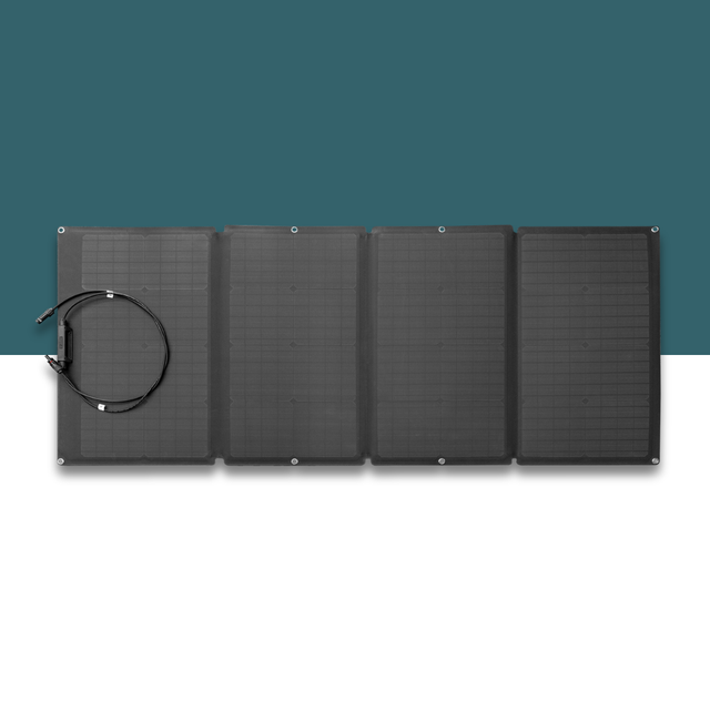Black solar panel with a cable on a white surface with a teal background