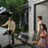 Family preparing to leave with luggage, standing near a modern house.