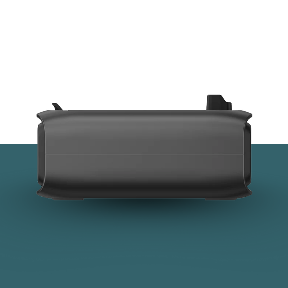 Black rectangular object on a green and white background