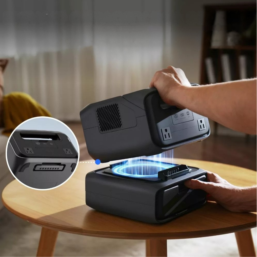 Person using a portable power station on a table with a close-up of its connectors.
