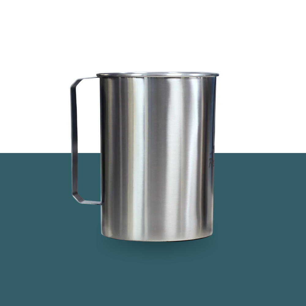 Stainless steel pitcher on a green and white background