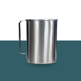Stainless steel pitcher on a green and white background
