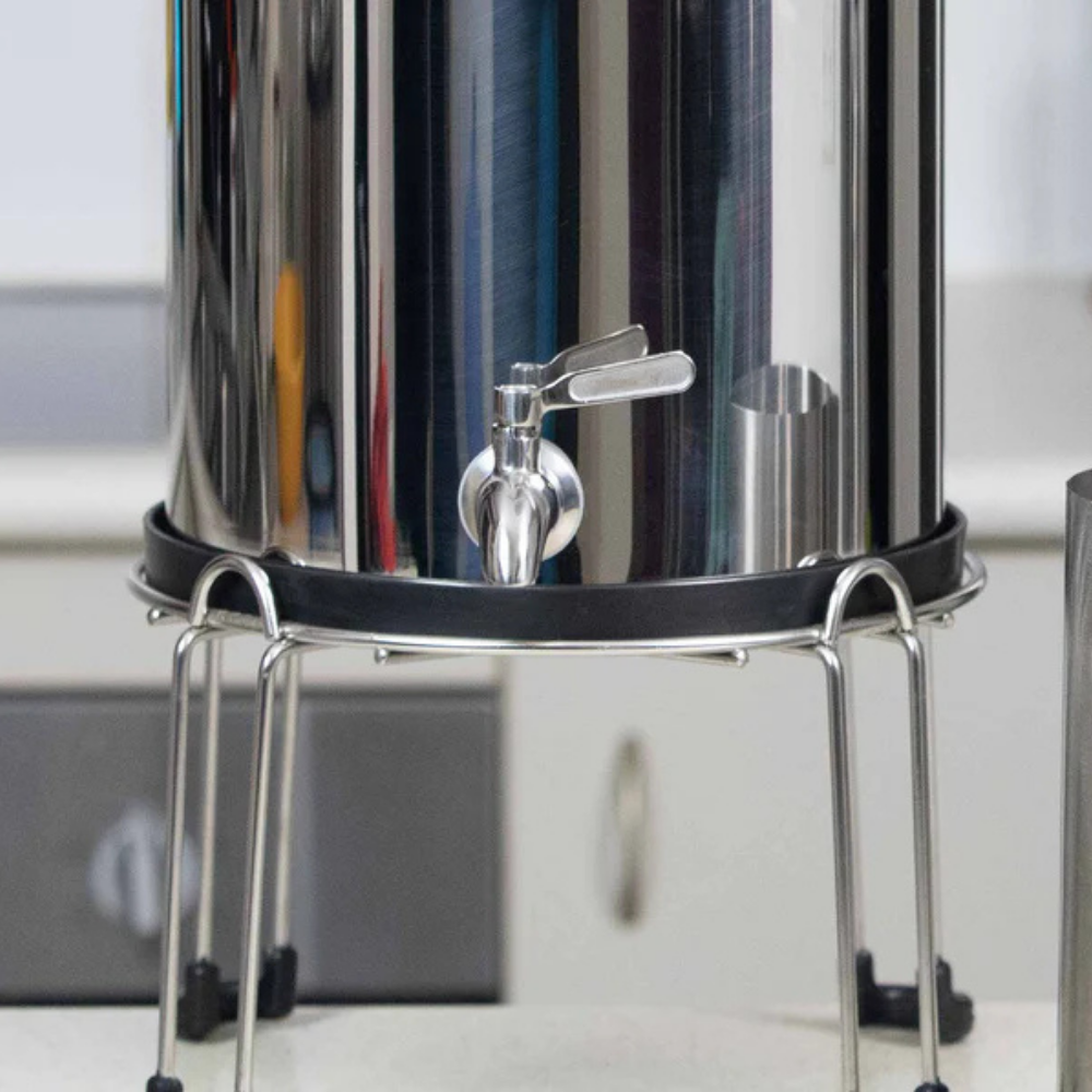 Metal water filter on a stand with a blurred background