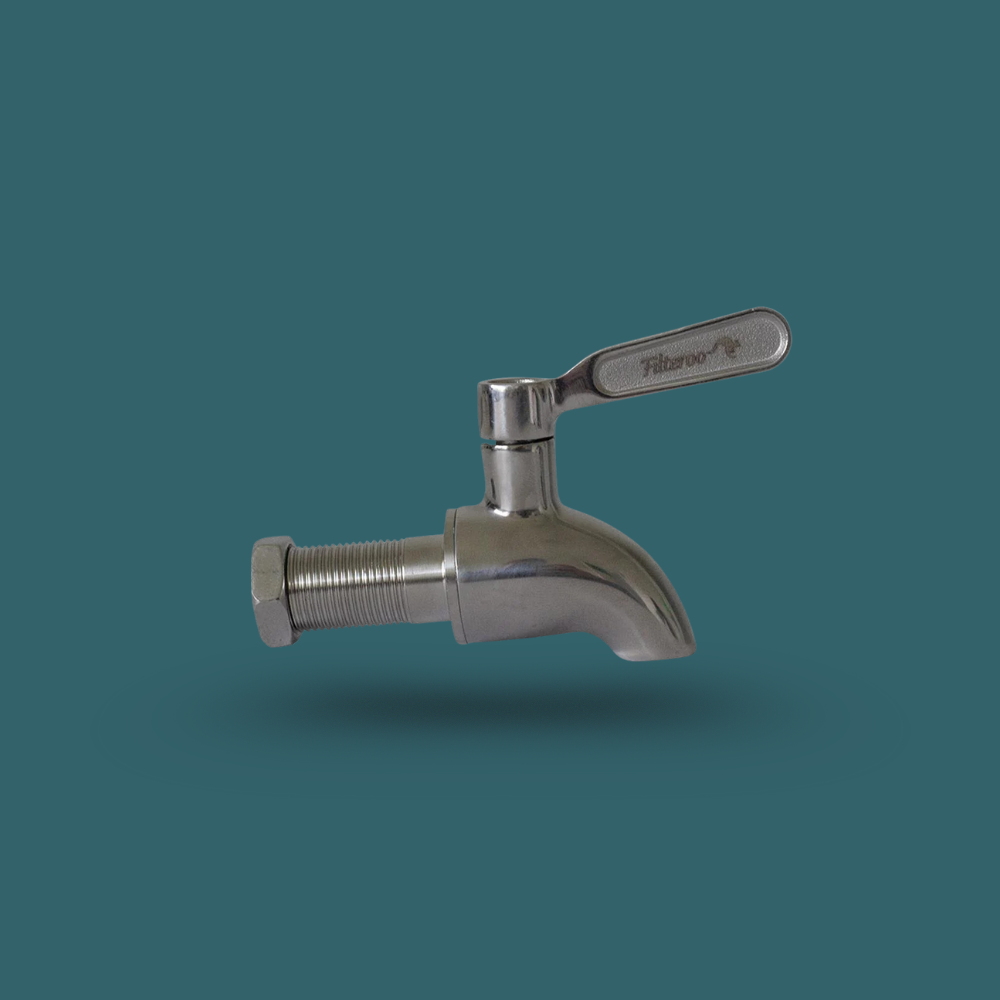 Metal faucet on a teal background