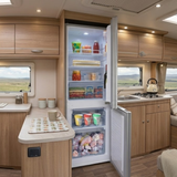 Open GECKO 139L 12V/24V Portable Upright Fridge Freezer  in a kitchen with wooden cabinets and a view of a field outside.