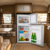 Open refrigerator in a camper kitchen with food items inside