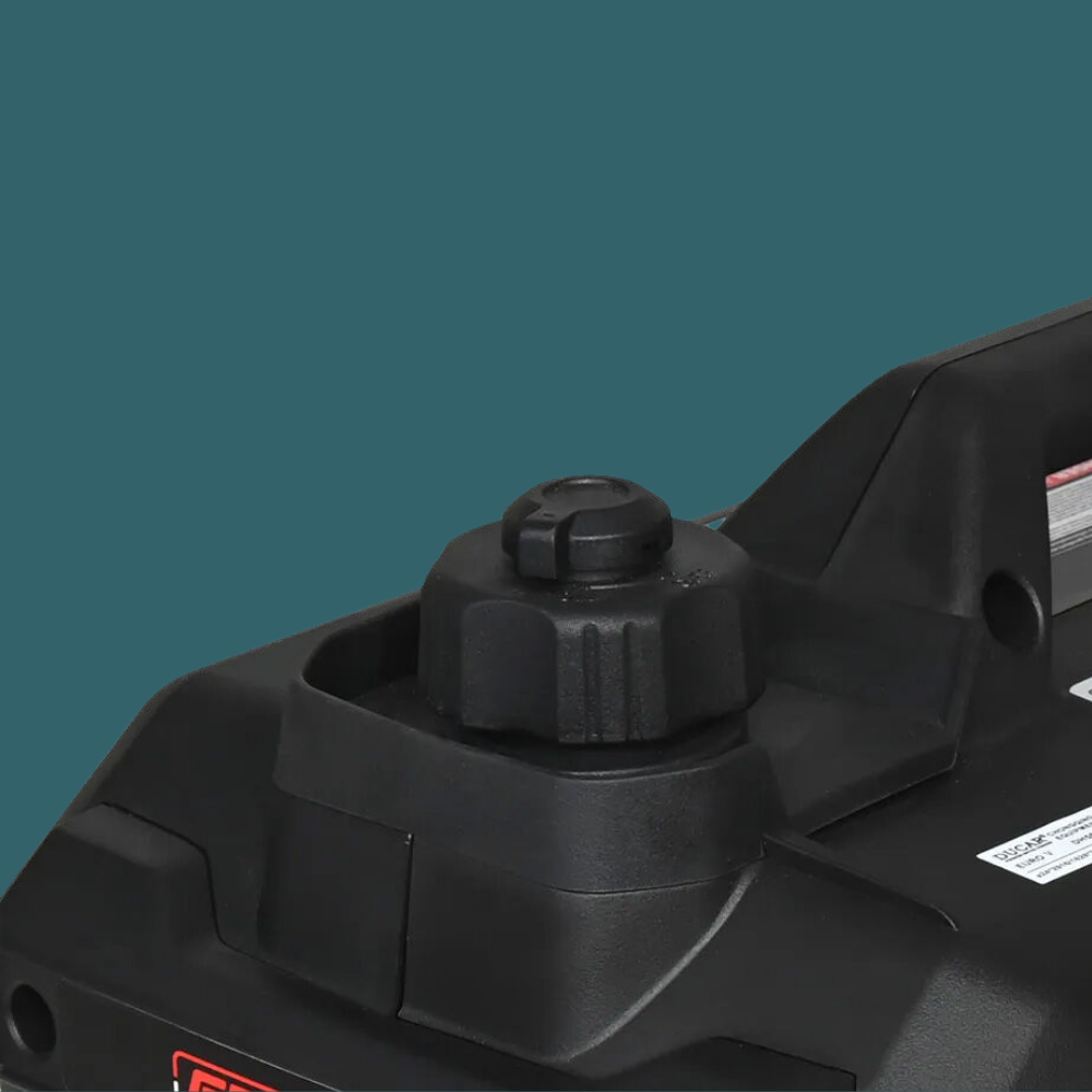 Close-up of a black power tool on a teal background